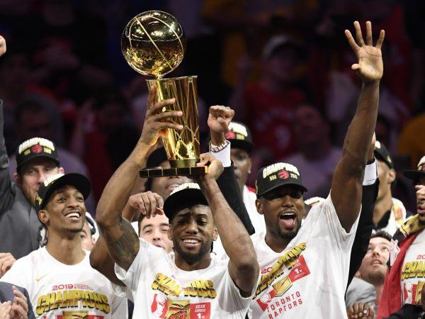 Toronto Raptors forward Kawhi Leonard, centre, holds Larry O'Brien NBA Championship Trophy after defeating the Golden State Warriors basketball action in Game 6 of the NBA Finals in Oakland, Calif. on Thursday, June 13, 2019. Raptors have won their first NBA title in franchise history. (Frank Gunn/The Canadian Press)