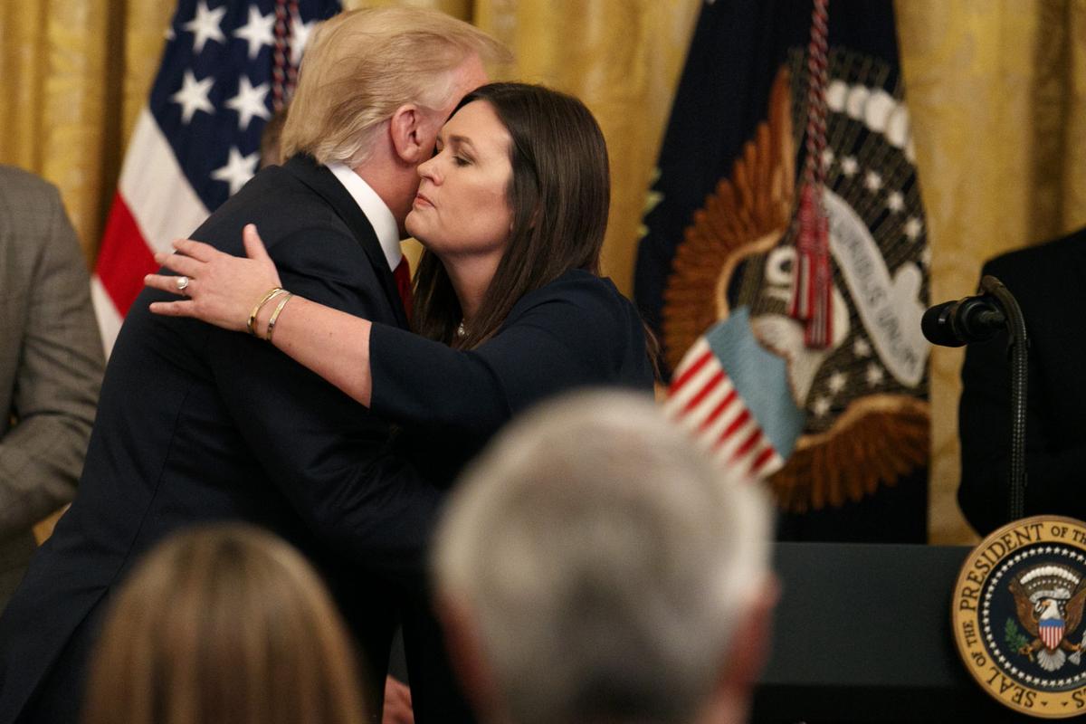 President Donald Trump hugs White House press secretary Sarah Sanders as he pauses from speaking about second chance hiring to publicly thank the outgoing press secretary in the East Room of the White House in Washington on June 13, 2019. (Jacquelyn Martin/AP Photo)
