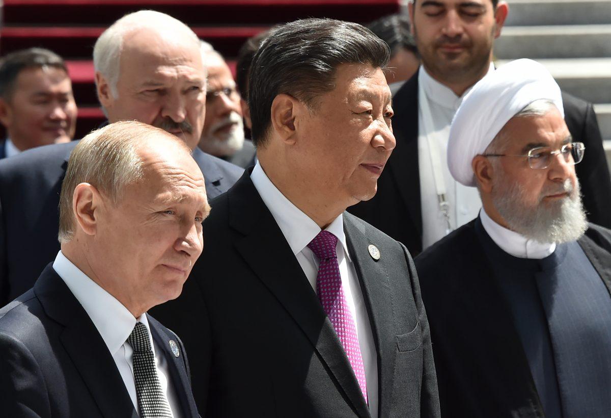 Russian President Vladimir Putin, Chinese leader Xi Jinping, and Iran's President Hassan Rouhani walk as they attend a meeting of the Shanghai Cooperation Organization (SCO) Council of Heads of State in Bishkek on June 14, 2019. (Vyacheslav Oseledko/AFP/Getty Images)