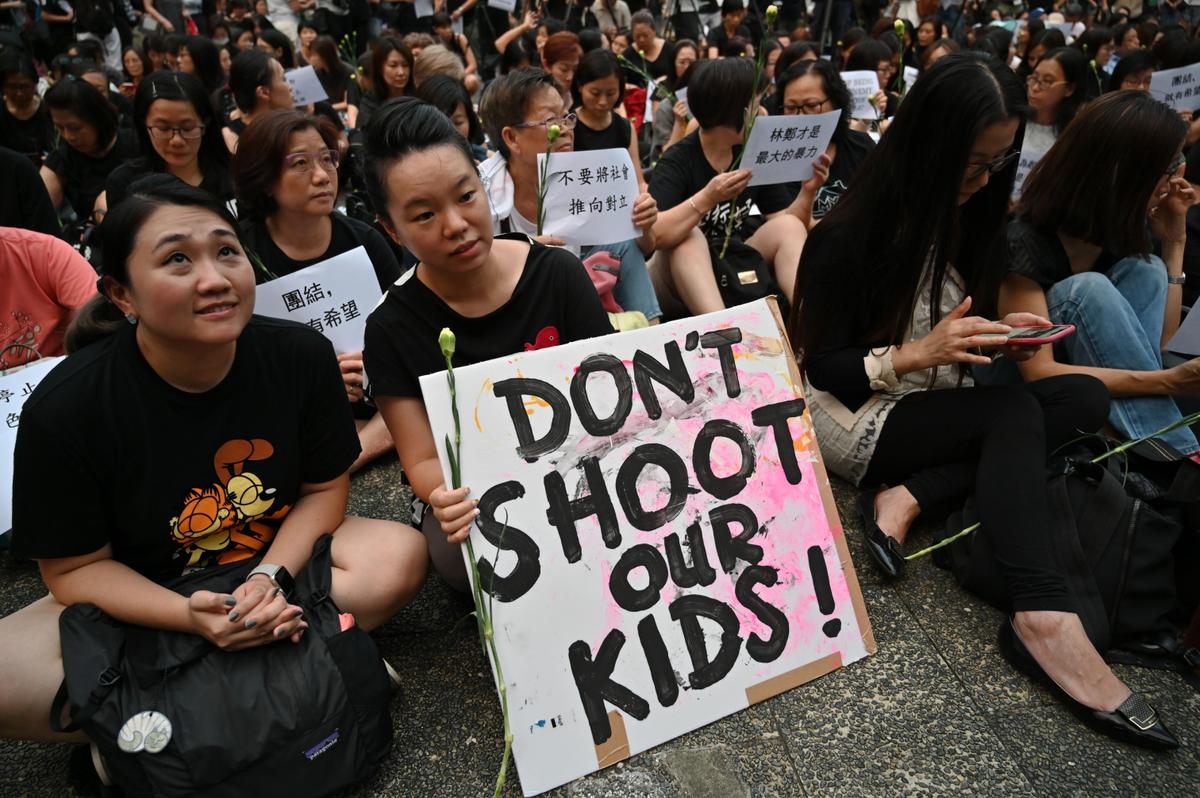 Protesters attend the 'Hong Kong Mothers Anti-Extradition Rally', to call out the city's police using rubber bullets, bean bags, and other implements to disperse crowds during earlier demonstrations against a proposed extradition bill, in Hong Kong on June 14, 2019. (Hector Retamal/Getty Images)