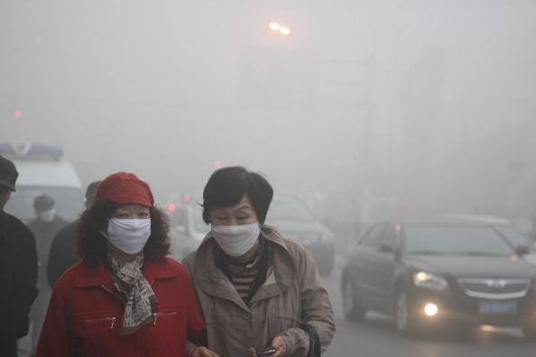 Women walking through smog in Harbin. (VCG via Getty Images)