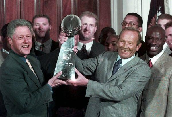 Then President Clinton (L), and Denver Broncos owner Pat Bowlen hold the Vince Lombardi Trophy during a ceremony at the White House where the president honored the Super Bowl XXXII champions on June 16, 1998. (Greg Gibson/AP Photo)