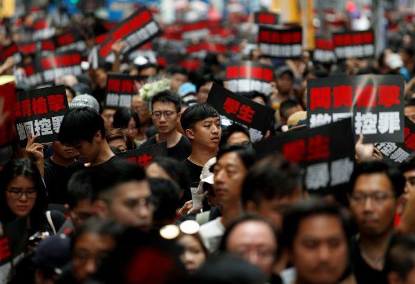 Protesters hold placards as they attend a demonstration demanding Hong Kong's leaders to step down and withdraw the extradition bill, in Hong Kong on June 16, 2019. (Reuters/Jorge Silva)