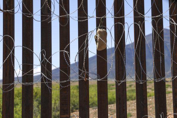 A carpet shoe, usually worn by smugglers and illegal aliens, is caught in the concertina wire on the U.S.-Mexico border fence near Sierra Vista, Arizona, on May 8, 2019. (Charlotte Cuthbertson/The Epoch Times)