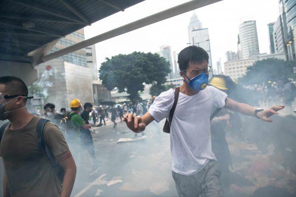Protesters run as tear gas is fired during a protest against a proposed extradition law on June 12, 2019, in Hong Kong, Hong Kong. (Billy H.C. Kwok/Getty Images)