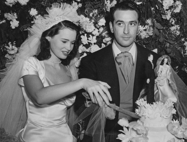 American heiress, artist, socialite, writer and fashion designer, Gloria Vanderbilt, with her first husband, agent, and movie producer Pat DiCicco (1909 - 1978) at their wedding reception, held at the home of Vanderbilt's mother, in Beverly Hills, Calif., on Dec. 28, 1941. (Keystone/Hulton Archive/Getty Images)