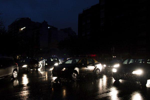 Cars drive through an unlit street during a blackout in Buenos Aires, Argentina on June 16, 2019. (Tomas F. Cuesta/Photo via AP)