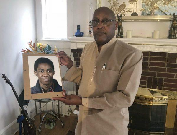 Dia Khafra, father of the deceased worker Askia Khafra, holds a photo of his son in his Silver Springs, Md., home in a file photo. (Michael Kunzelman/AP Photo)