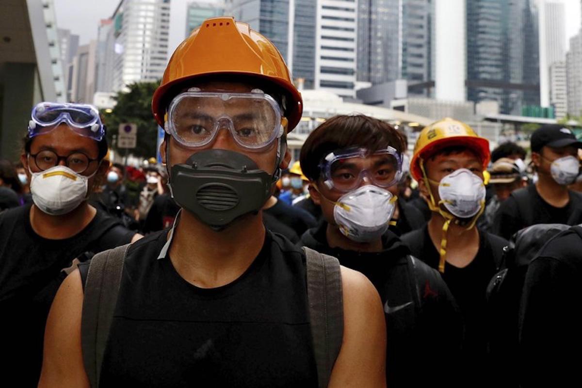 Protesters wearing protection gears march toward the Legislative Council as they continue to protest against the extradition bill in Hong Kong on June 17, 2019. Hong Kong police and protesters faced off Monday as authorities began trying to clear the streets of a few hundred who remained near the city government headquarters after massive demonstrations that stretched deep into the night before.(Vincent Yu/AP)