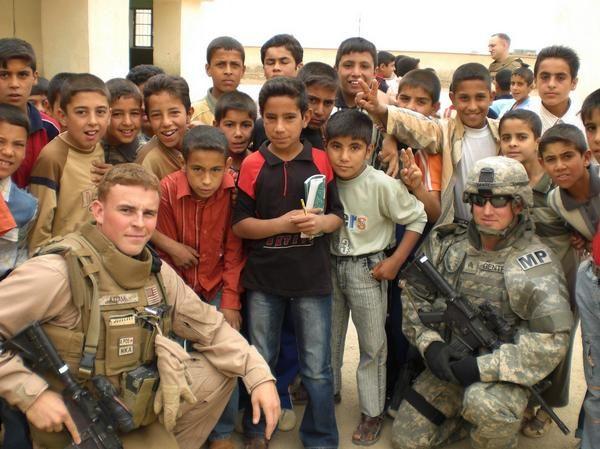 Brian Dix (L) with children during a deployment to Iraq. (Courtesy of Brian Dix)