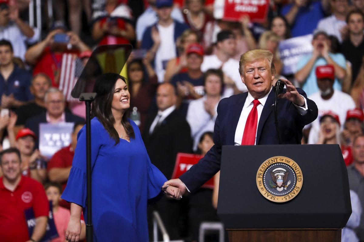 President Donald Trump brings outgoing White House Press Secretary Sarah Sanders on stage during his 2020 re-election event in Orlando, Fla., on June 18, 2019. (Charlotte Cuthbertson/The Epoch Times)