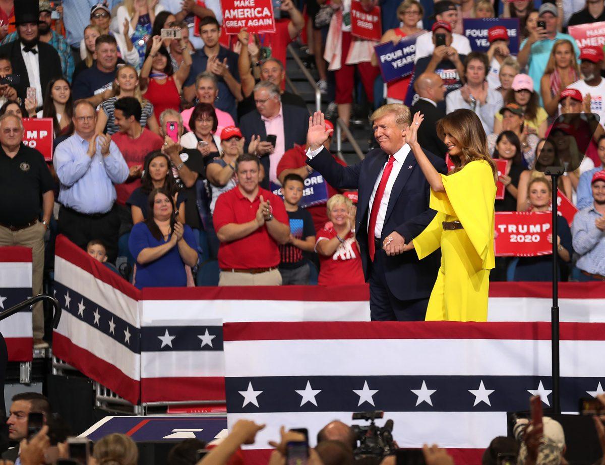 President Donald Trump and First Lady Melania Trump arrive on stage as President Trump prepares to announce his candidacy for a second presidential term at the Amway Center in Orlando, Florida, on June 18, 2019. President Trump is set to run against a wide open Democratic field of candidates. (Joe Raedle/Getty Images)