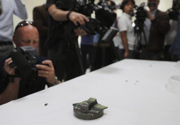 Journalists take pictures of a magnet the U.S. Navy says came from a limpet mine that didn't explode on a Japanese-owned oil tanker at a 5th Fleet base, during a trip organized by the Navy for journalists, near Fujairah, United Arab Emirates on June 19, 2019. (Kamran Jebreili/Photo via AP)