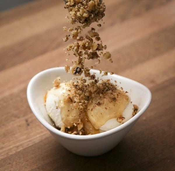 Greek yogurt topped with honey and a flurry of crushed walnuts. (Samira Bouaou/The Epoch Times)