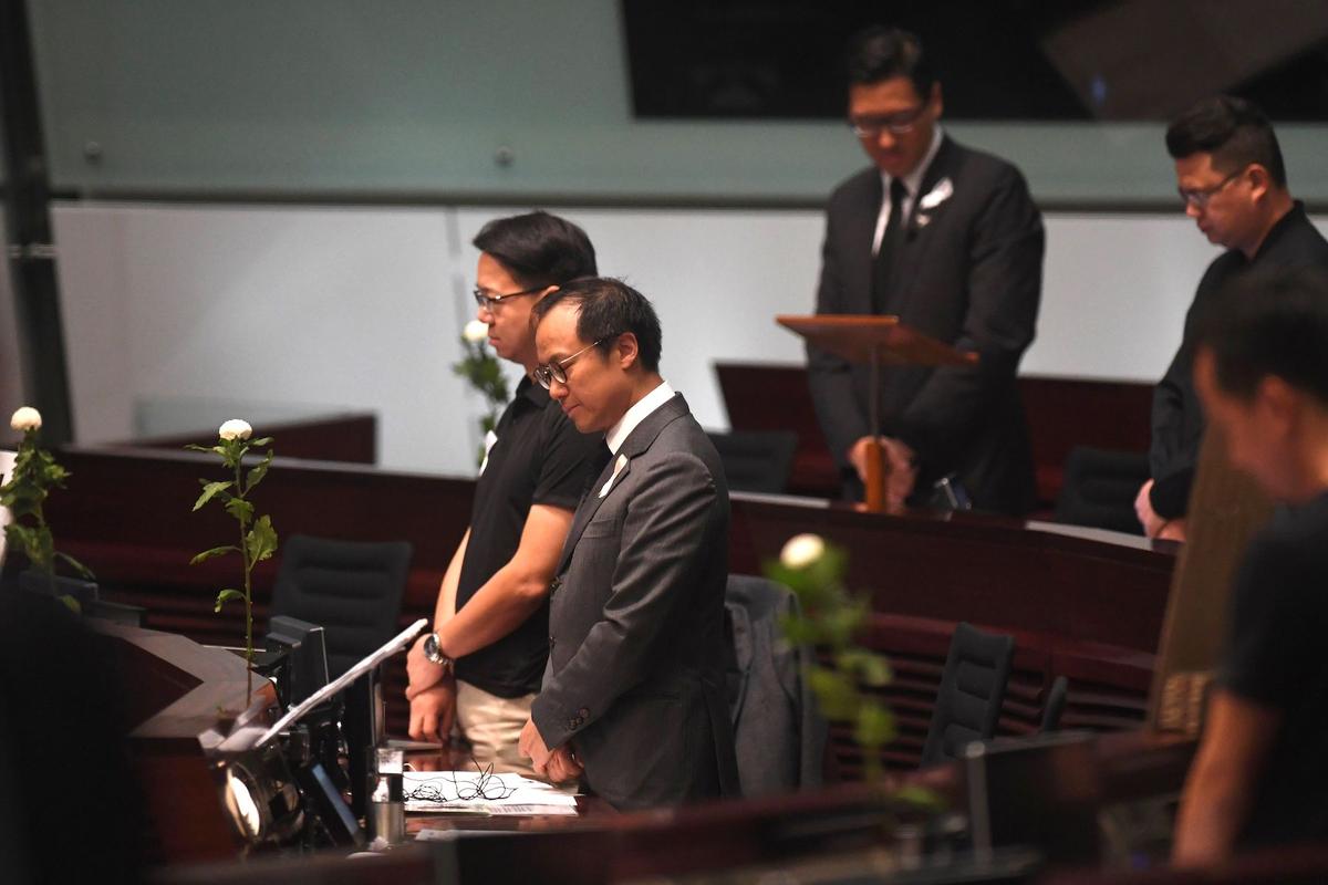 Pro-democracy lawmakers hold five minutes of silence in the Legislative Council in Hong Kong on June 19, 2019, for a man who fell to his death on June 15 during a protest against a controversial extradition bill. (Anthony Wallace/AFP/Getty Images)