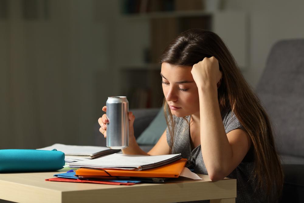 Many young people are increasingly addicted to energy drinks to help them keep up with busy schedules (Illustration - Antonio Guillem/Shutterstock)