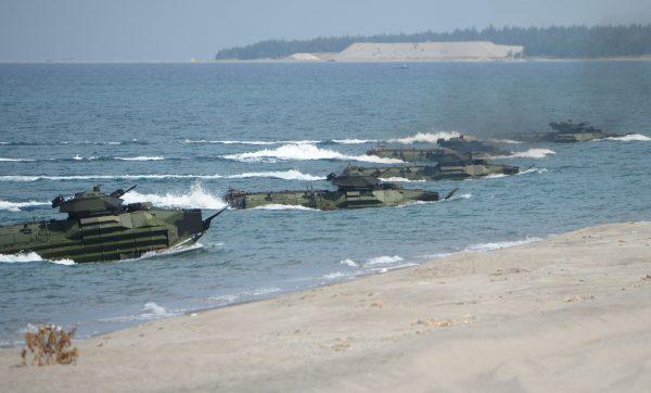 US Marine Amphibious Assault Vehicles (AAV) prepare to hit the beach during the amphibious landing exercises as part of the annual joint US-Philippines military exercise on the shores of San Antonio town, facing the South China sea, Zambales province on April 11, 2019. (TED ALJIBE/AFP/Getty Images)