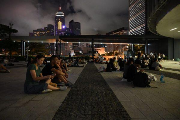 People sit outside the Legislative Council Complex in support of demonstrators, who opposed the controversial extradition law, in Hong Kong on June 20, 2019. (HECTOR RETAMAL/AFP/Getty Images)