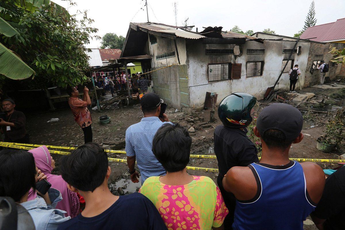 Locals look at a house used as a factory producing matchsticks after a fire swept through, at Binjai district in Langkat, North Sumatra province, Indonesia, on June 21, 2019. (Antara Foto. Antara Foto/Adiva Niki/ via Reuters)