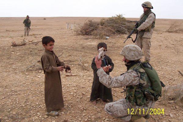 Nick Benas handing out stuffed animals to Kurdish children. (Courtesy of Nick Benas)