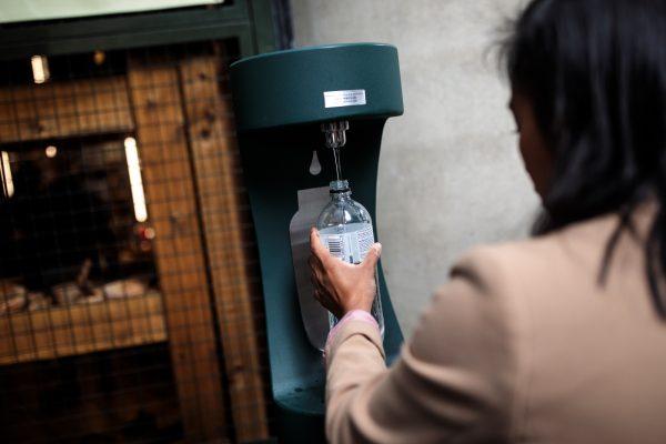 A woman refills a plastic bottle at a public water fountain in Borough Market in London on Aug. 28, 2018. (Jack Taylor/Getty Images)