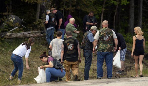 People recover personal items from the scene of a fatal accident on Route 2 in Randolph, N.H., on June 22, 2019. (Paul Hayes/Caledonian-Record via AP)
