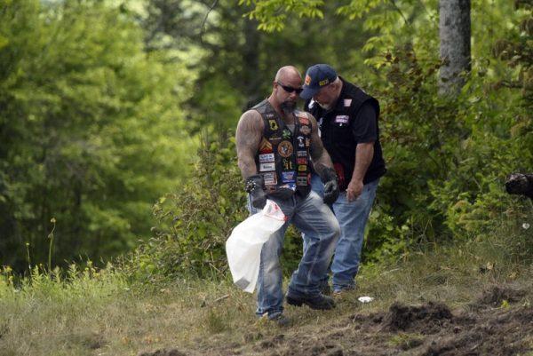 Motorcyclists recover personal items from the scene of a fatal accident on Route 2 in Randolph, N.H., on June 22, 2019. (Paul Hayes/Caledonian-Record via AP)