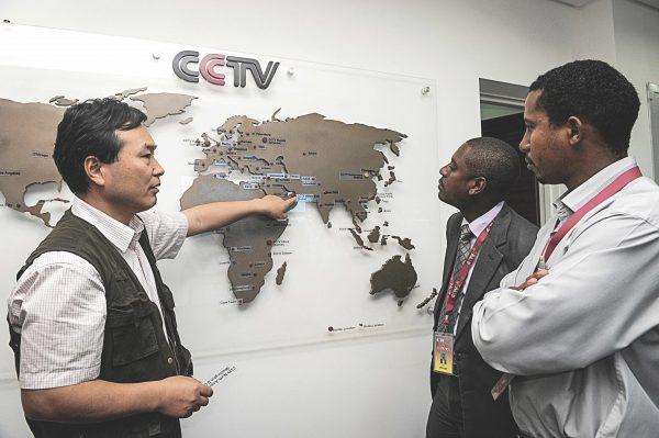 Pang Xinhua (L), the managing editor of China Central Television Africa, talks to local journalists in Nairobi, Kenya, as he shows them how the organization has expanded in different parts of Africa, on June 12, 2012. (Simon Maina/AFP/GettyImages)