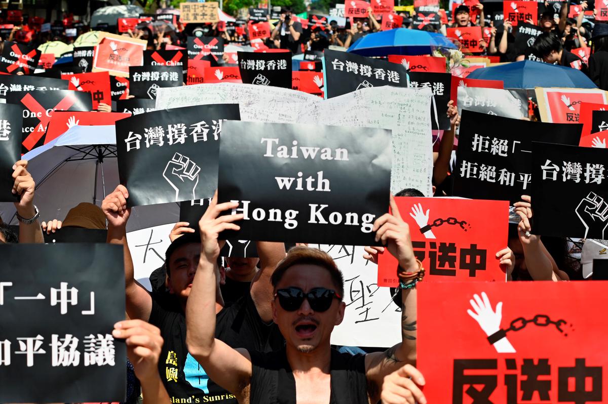 Protesters display placards during a demonstration in Taipei on June 16, 2019, in support of the continuing protests taking place in Hong Kong. (Sam YEH/AFP/Getty Images)
