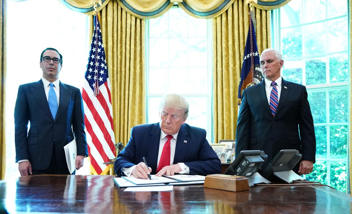 President Donald Trump signs with Vice President Mike Pence(R) and Secretary of Treasury Steven Mnuchin at the White House on June 24, 2019, 'hard-hitting sanctions' on Iran. (Mandel Ngan/AFP/Getty Images)