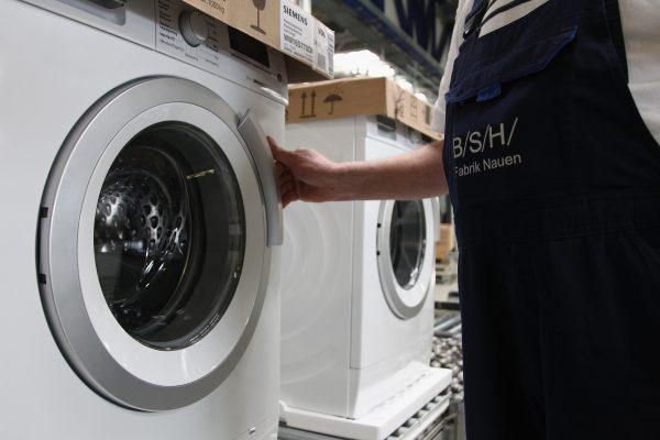 A worker controls completed Washing Machines at the BSH on February 8, 2010 in Nauen, Germany. (Andreas Rentz/Getty Images)