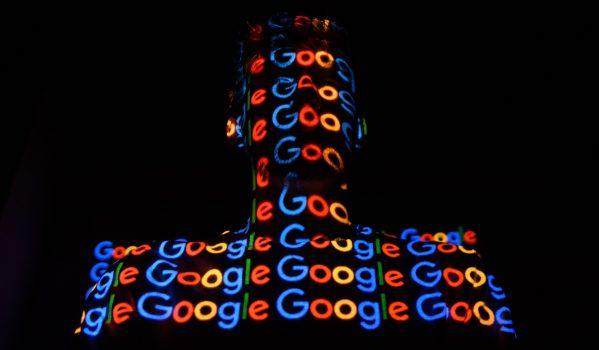 The Google logo is projected onto a man on in London on Aug. 9, 2017. (Leon Neal/Getty Images)