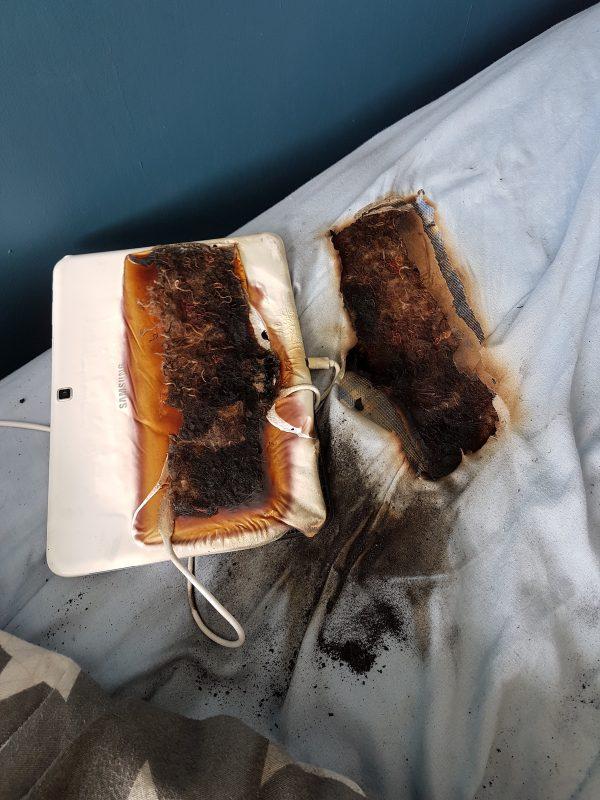 A picture of a melted and burned tablet and mattress, which occurred when the device was left plugged in for over 24 hours, according to Staffordshire Fire and Rescue Service, on June 19, 2019. (SFRS)
