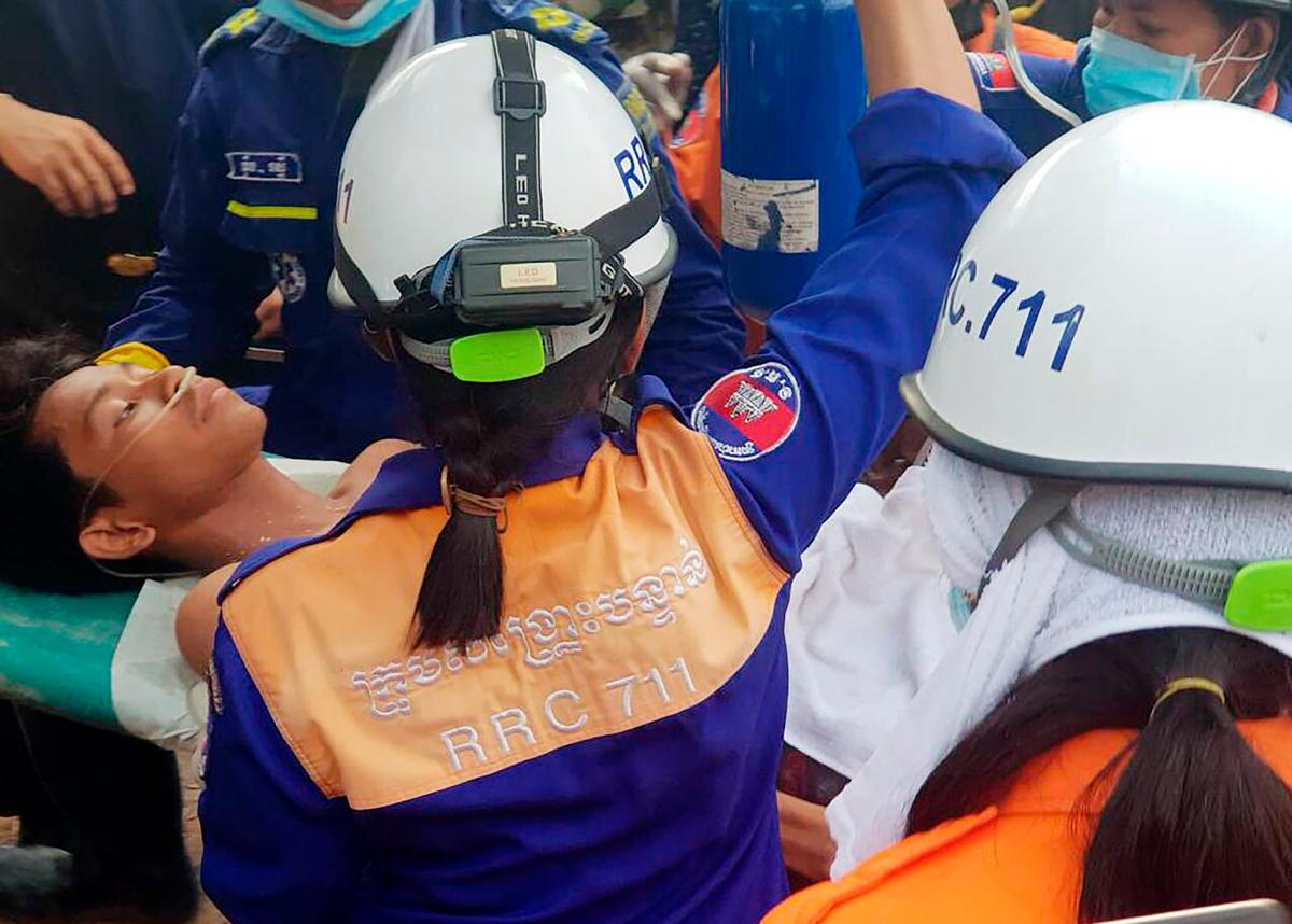 Rescuers carry a survivor from the site of a collapsed building in Sihanouk Province, Cambodia on June 24, 2019. (Preah Sihanouk provincial authorities via AP)