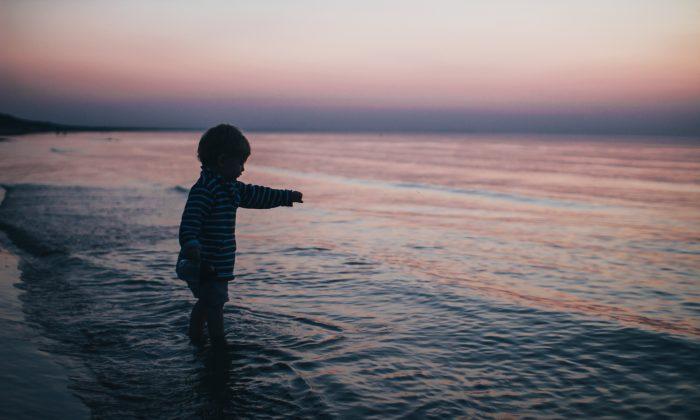 A Child playing at the seashore. (Daiga Ellaby/Unsplash)
