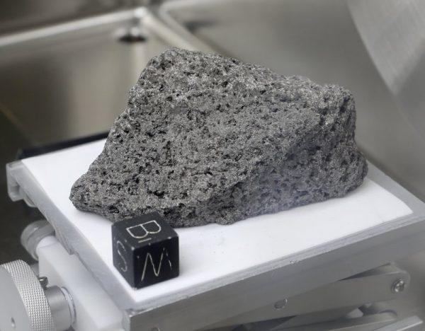 Collected during Apollo 17, a 3.5 billion-year-old basalt rock known as "The Children of the World" or "The Goodwill Sample" is displayed in the lunar lab at the NASA Johnson Space Center in Houston on June 17, 2019. (Michael Wyke/AP)