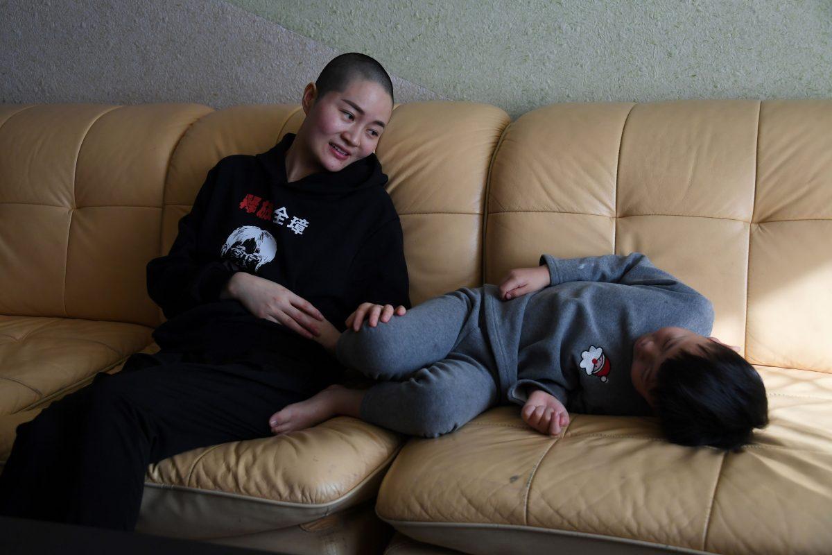 Li Wenzu (L), the wife of imprisoned lawyer Wang Quanzhang, talks with their son Wang Guangwei (R) at their home in Beijing on Jan. 28, 2019. (Greg Baker/AFP/Getty Images)