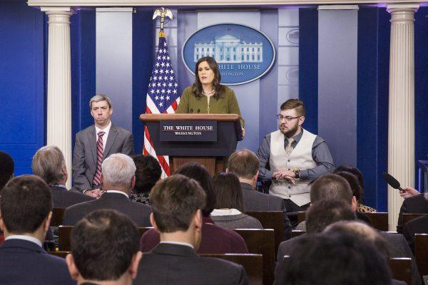 White House Press Secretary Sarah Huckabee Sanders with retired Marine Corps Sgt. John Peck (R) and Staff Sgt. Liam Dwyer during a White House press briefing in Washington on March. 5, 2018. (Samira Bouaou/The Epoch Times)