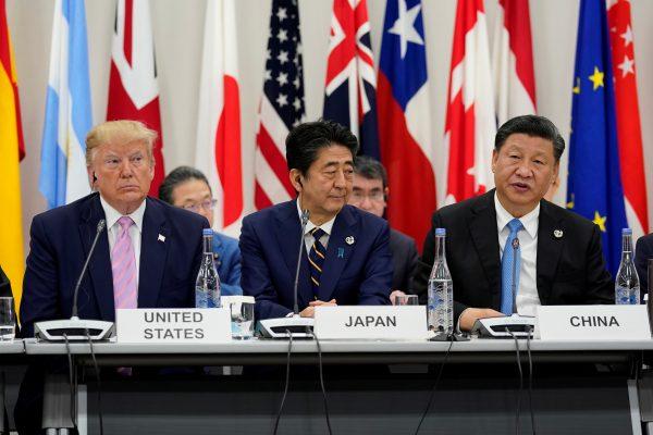 Japan's Prime Minister Shinzo Abe is flanked by President Donald Trump and Chinese leader Xi Jinping during a meeting at the G20 leaders summit in Osaka, Japan on June 28, 2019. (Kevin Lamarque/Reuters)