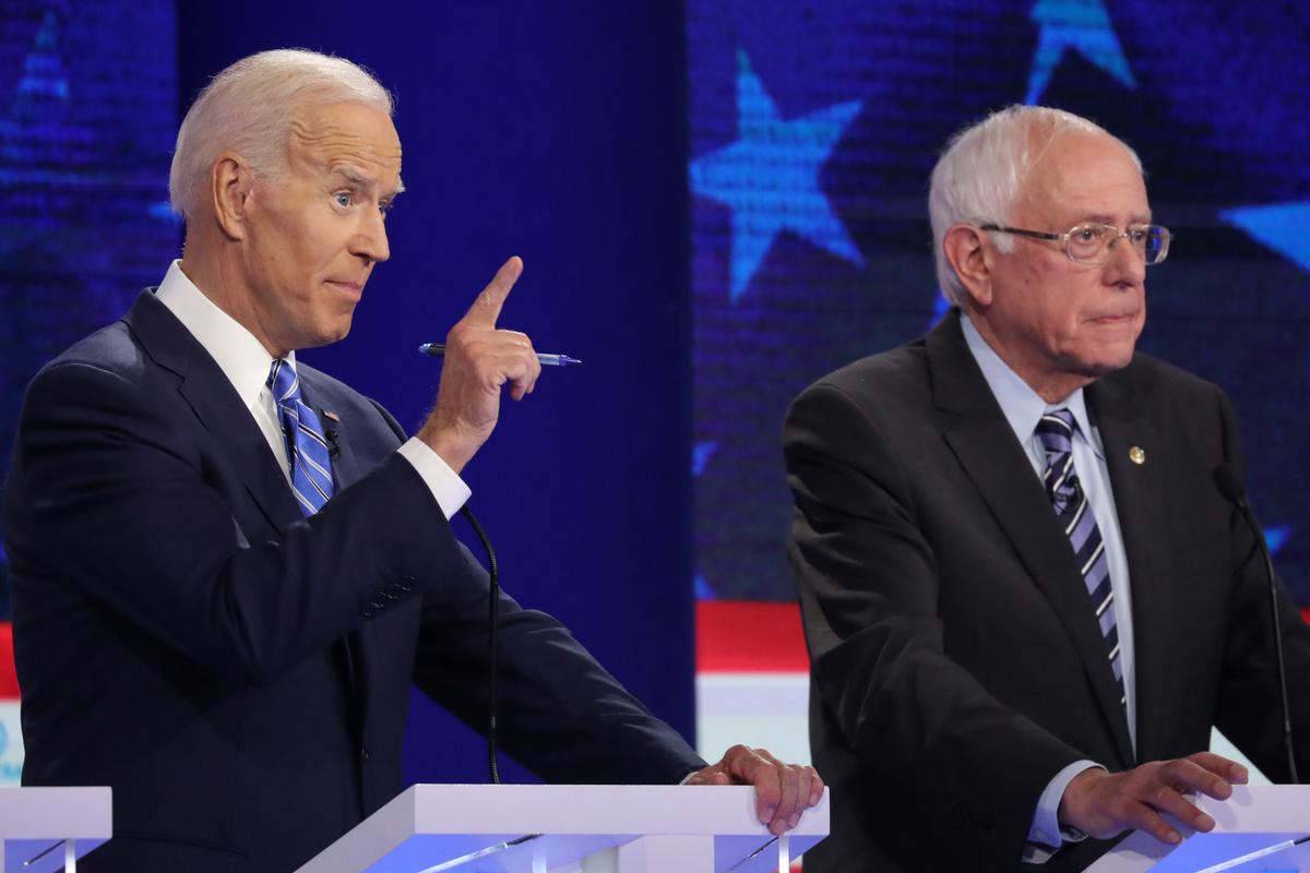 Democratic presidential candidate former Vice President Joe Biden speaks as Sen. Bernie Sanders (I-Vt.) looks on during the second night of the first Democratic presidential debate in Miami, Florida, on June 27, 2019. A field of 20 Democratic presidential candidates was split into two groups of 10 for the first debate of the 2020 election, taking place over two nights at Knight Concert Hall of the Adrienne Arsht Center for the Performing Arts of Miami-Dade County, hosted by NBC News, MSNBC, and Telemundo. (Drew Angerer/Getty Images)