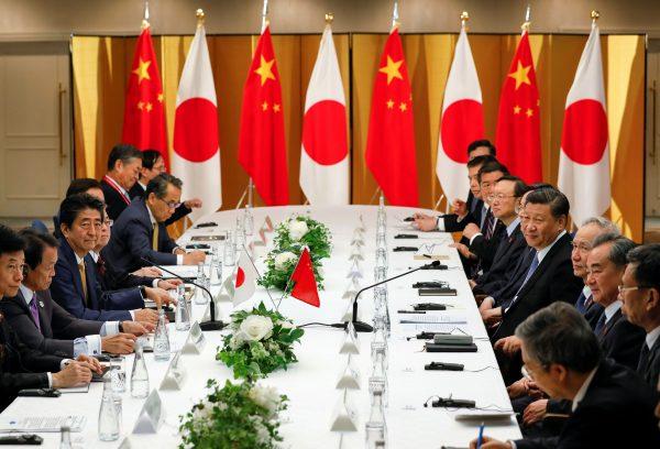 Chinese leader Xi Jinping and Japanese Prime Minister Shinzo Abe talk at the start of talks at a Osaka hotel, prior to the G20 Summit at the International Exhibition Center in Osaka, western Japan, June 27, 2019. (Kimimasa Mayama/Pool via REUTERS)