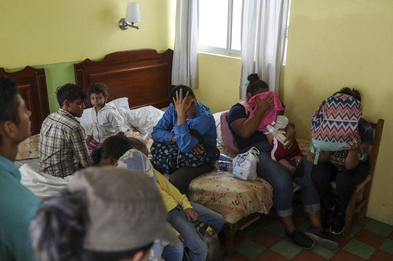 Central American migrants sit together inside a room at the Latino hotel during a raid by Mexican immigration agents in Veracruz, Mexico, June 27, 2019. (AP Photo/Felix Marquez)