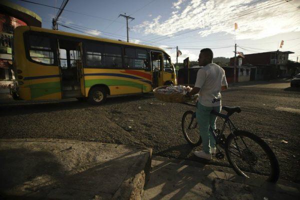 A bread seller waits to cross a street at the Alta Vista neighborhood, of San Martin, El Salvador, on June 27, 2019. (Salvador Melendez/Photo via AP)