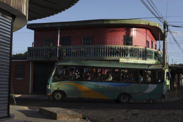 A bus runs on one of the narrow streets of the Alta Vista neighborhood of San Martin, El Salvador, early on June 27, 2019. (Salvador Melendez/Photo via AP)