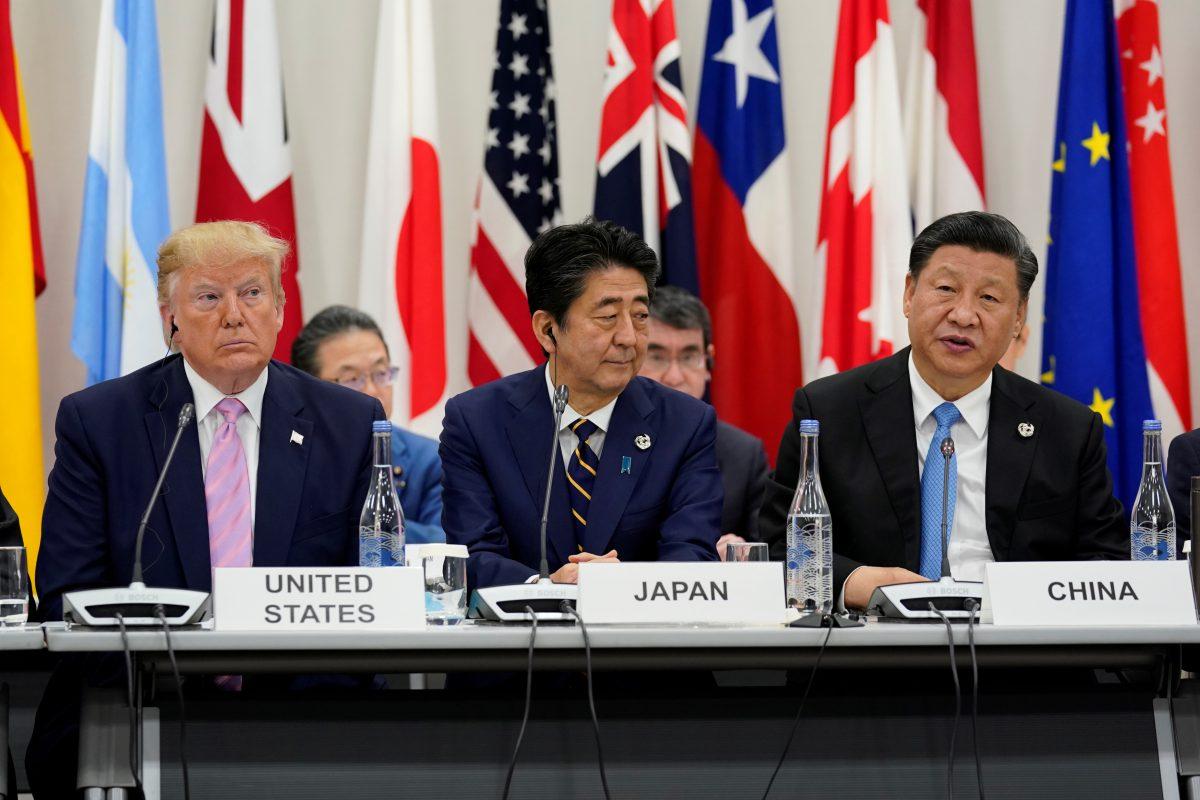 Japan's Prime Minister Shinzo Abe is flanked by U.S. President Donald Trump and Chinese leader Xi Jinping during a meeting at the G20 leaders summit in Osaka, Japan, on June 28, 2019. (Kevin Lamarque/Reuters)