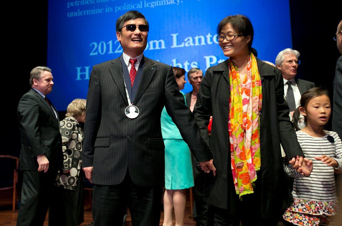 Chinese human rights activist Chen Guangcheng (3rd L) stands with his wife Yua Weijing (3rd R) following a ceremony where he was presented the Tom Lantos Human Rights Prize in Washington, on Jan. 29, 2013. (Win McNamee/Getty Images)