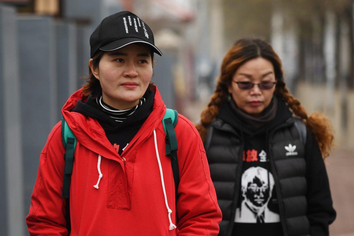 Li Wenzu (L), the wife of detained human rights lawyer Wang Quanzhang, walks on the outskirts of Beijing to Tianjin, where she believes her husband is being held, on April 5, 2018. (Greg Baker/AFP/Getty Images)