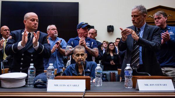 Retired Fire Department of New York Lieutenant and 9/11 responder Michael O'Connell, left, FealGood Foundation co-founder John Feal, center, and former Daily Show Host Jon Stewart, right, applaud following testimony from Retired New York Police Department detective and 9/11 responder Luis Alvarez during a House Judiciary Committee hearing on reauthorization of the September 11th Victim Compensation Fund on Capitol Hill on June 11, 2019, in Washington, DC. (Zach Gibson/Getty Images)
