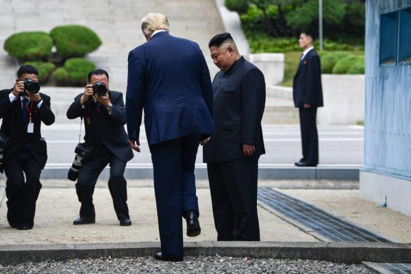 President Donald Trump steps into the northern side of the Military Demarcation Line that divides North and South Korea, as North Korea's leader Kim Jong Un looks on, in the Joint Security Area (JSA) of Panmunjom in the Demilitarized zone (DMZ) on June 30, 2019. (BRENDAN SMIALOWSKI/AFP/Getty Images)