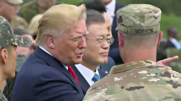 President Donald Trump and South Korean President Moon Jae-in are seen with Sean Morrow, commander of the UNC Security Battalion, at the demilitarized zone (DMZ) separating the two Koreas, in Paju, South Korea, on June 30, 2019. (South Korean Pool/Reuters TV)